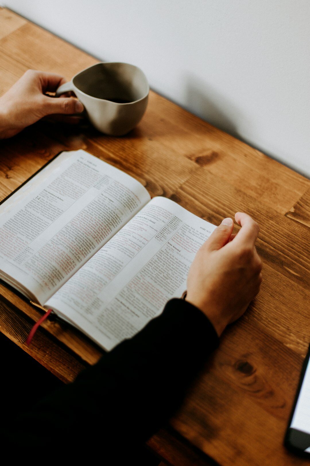 person reading book at desk